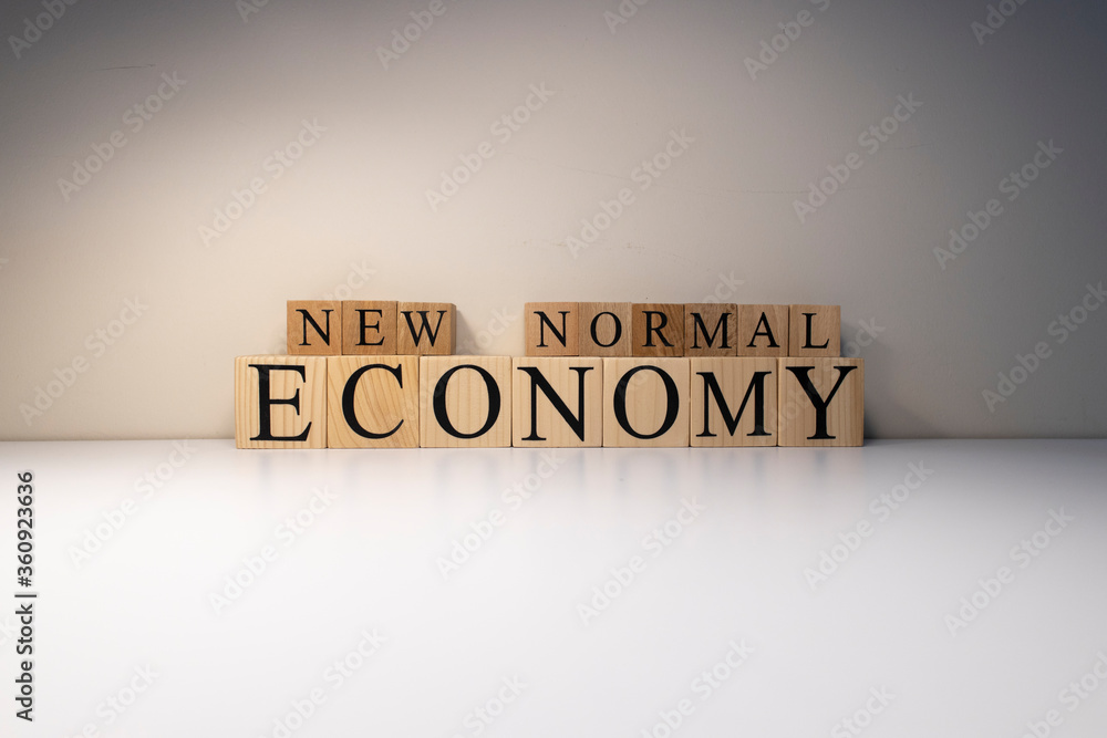 New normal economy text from wooden cubes. New normal economy text from wooden cubes.