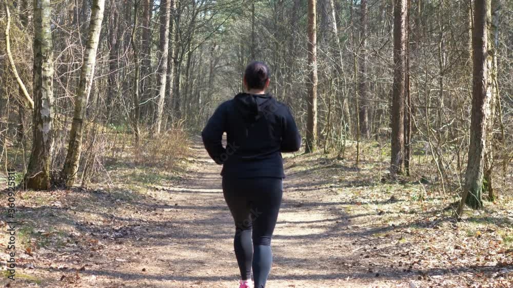 Woman running in the forest in 4K slow motion 60fps Woman running in the forest in 4K slow motion 60fps