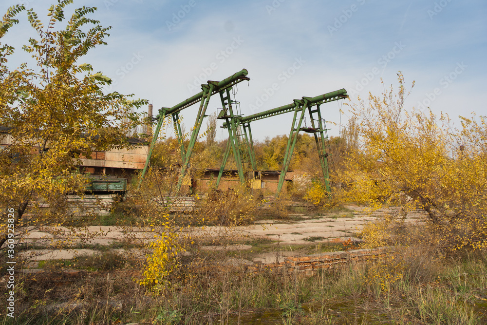 Old rusty gantry bridge crane in abandoned industrial area