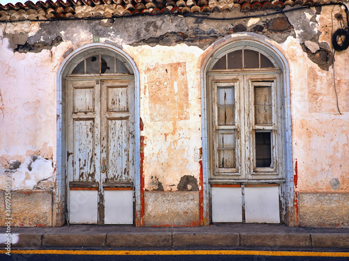 Front view of an old, dilapidated and rundown old town house in 