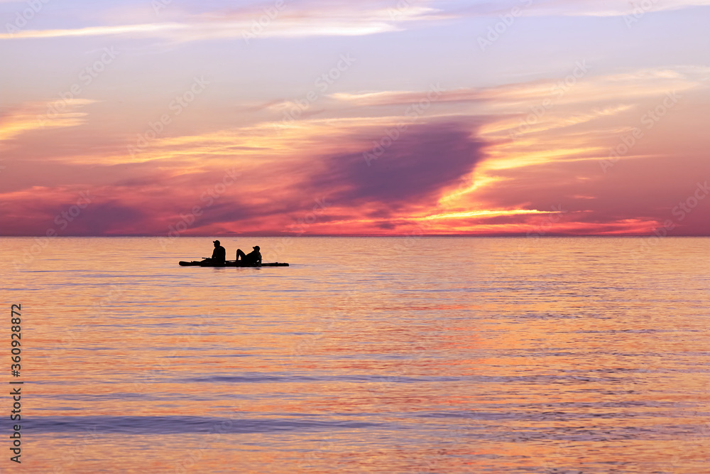 Fototapeta premium silhouette of a man in a boat