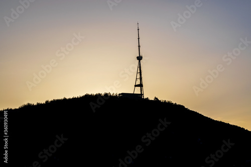 Cityscape of Tbilisi with the silhouette of Mount Mtatsminda and Tbilisi TV Broadcasting Tower during the colorful sunset. Tbilisi, Georgia