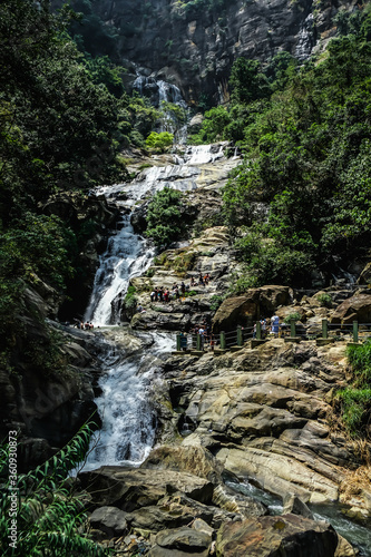 Ravana waterfall Sri Lanka. Crowded touristic spot called Ravana falls on a beautiful sunny day. Natural landmark in central Sri Lanka.