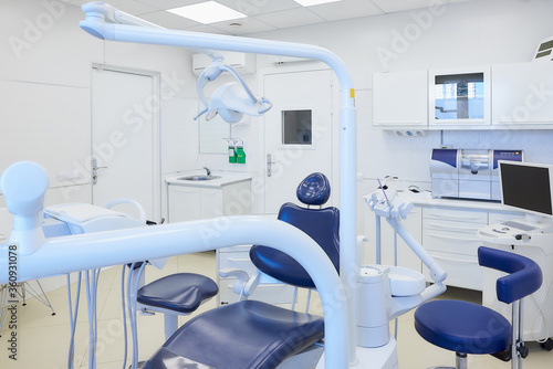 Fototapeta Naklejka Na Ścianę i Meble -  An interior of a dental office with white and blue furniture. Dentist’s office.