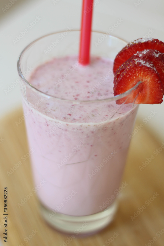 Delicious milk cocktail made of fresh strawberries in glass. Pink Delicious milk cocktail made of fresh strawberries in glass. Pink
