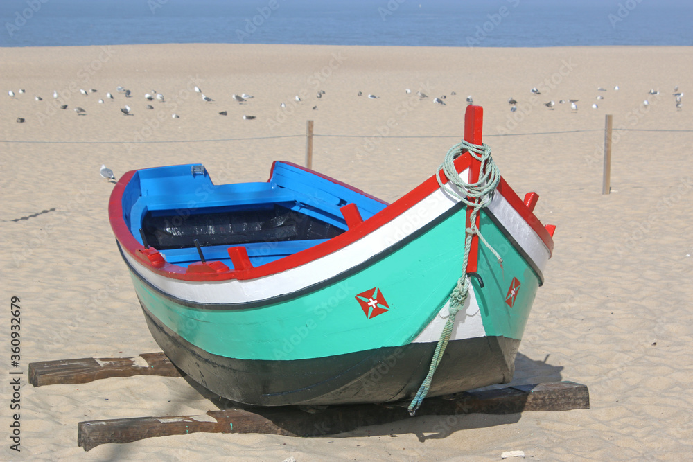 Fototapeta premium Traditional fishing boat on Nazare beach, Portugal 