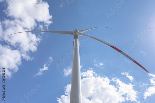 Wind turbines in a blue sky with clouds © Dmitry