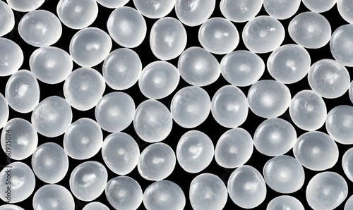 Close up picture of polypropylene granules on a black background. photo