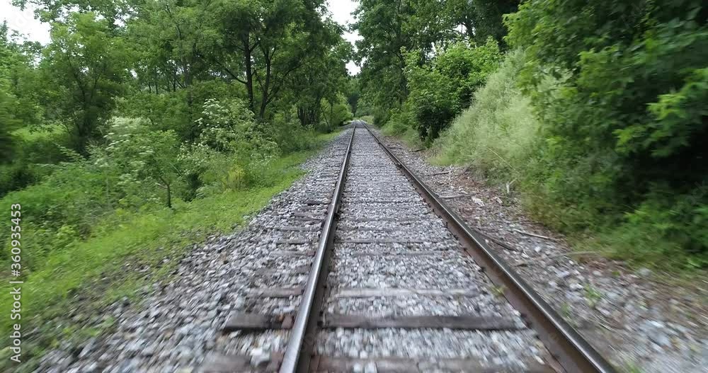 Traveling down freight train tracks, point of view, rural industrial area Traveling down freight train tracks, point of view, rural industrial area