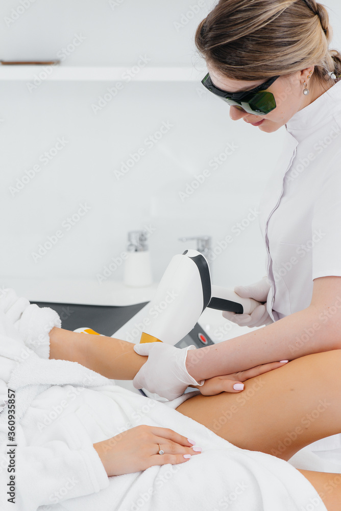 A beautiful young girl will undergo laser hair removal with modern equipment in a Spa salon. Beauty salon. Body care A beautiful young girl will undergo laser hair removal with modern equipment in a Spa salon. Beauty salon. Body care