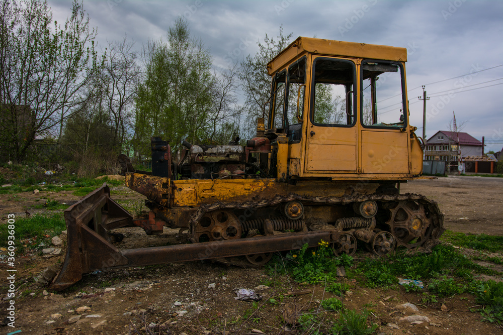 Broken tractor on tracks in the field Broken tractor on tracks in the field