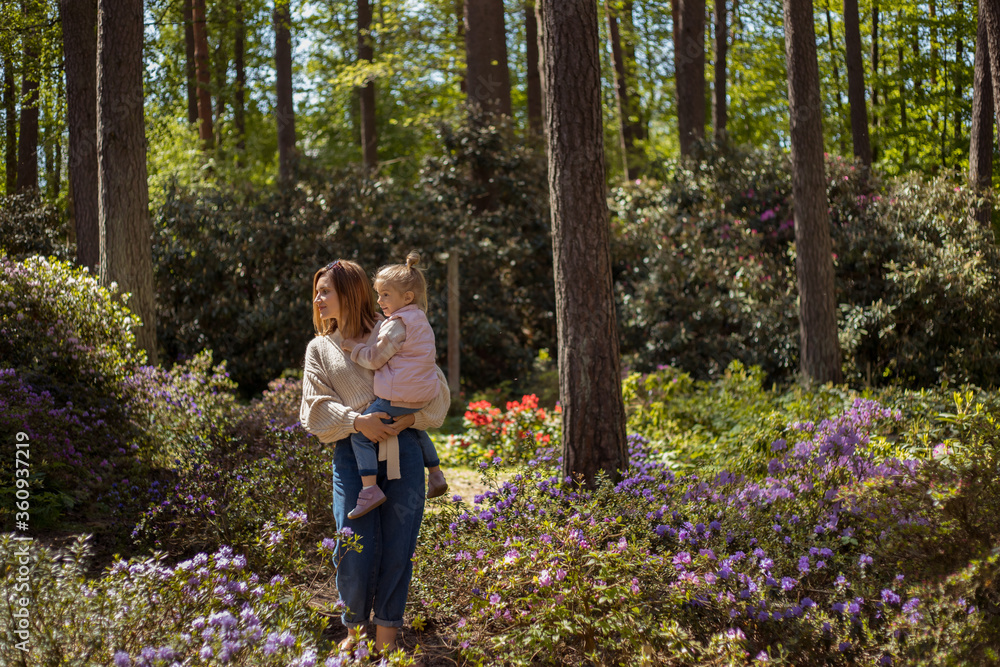 Mother and daughter walking in rhododendron botanical garden. Mother and daughter walking in rhododendron botanical garden.