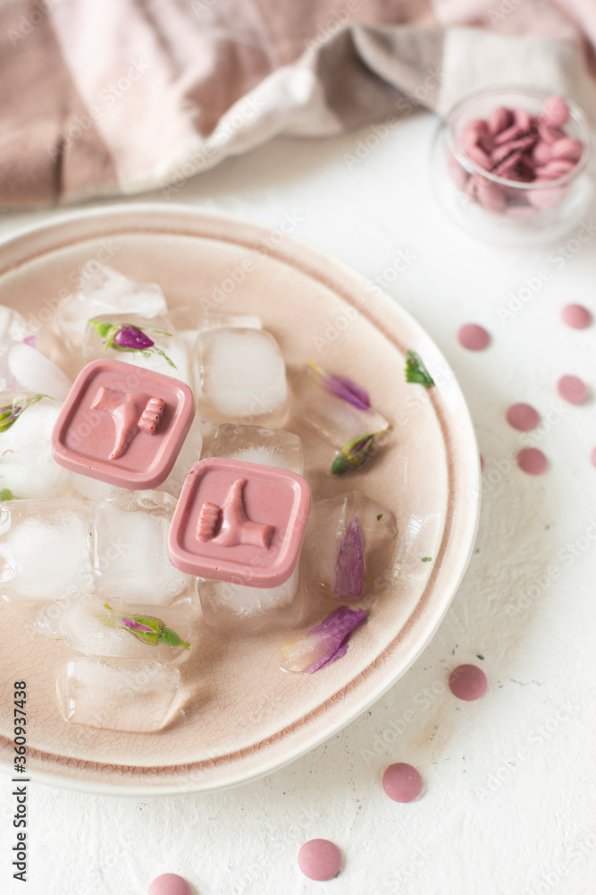 Pink chocolates lie on ice. Place for photo.
Pink chocolates lie on ice. Place for photo.