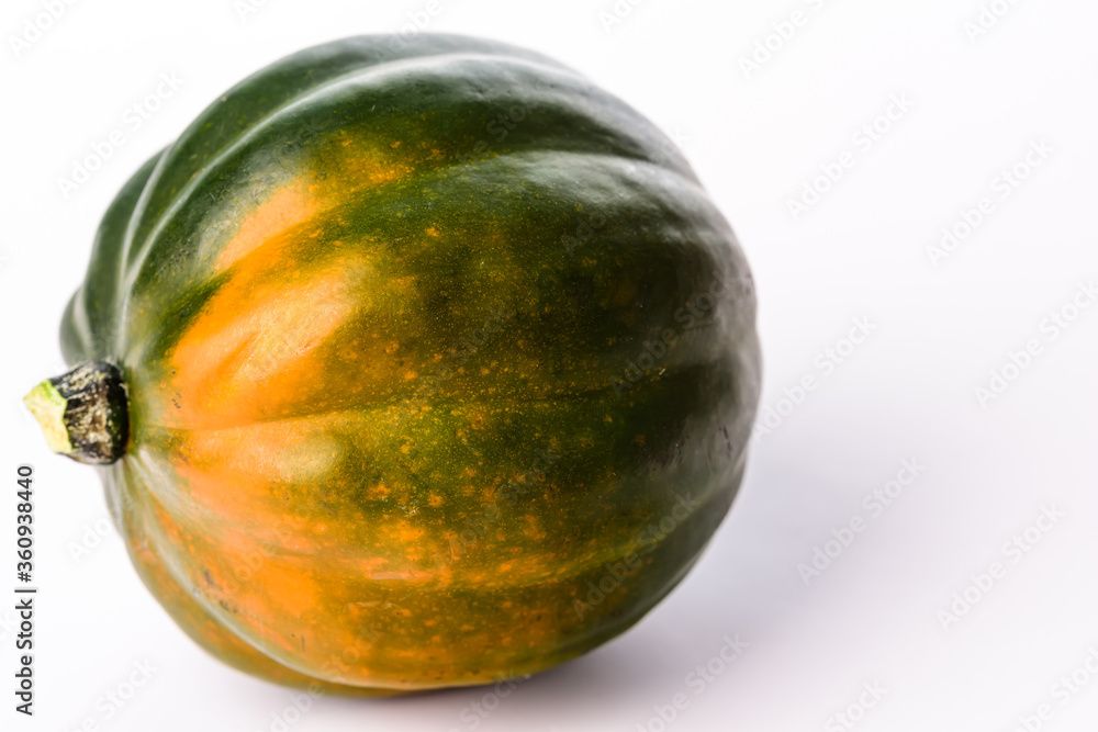 Green and orange acorn pumpkin on a white background. Green and orange acorn pumpkin on a white background.