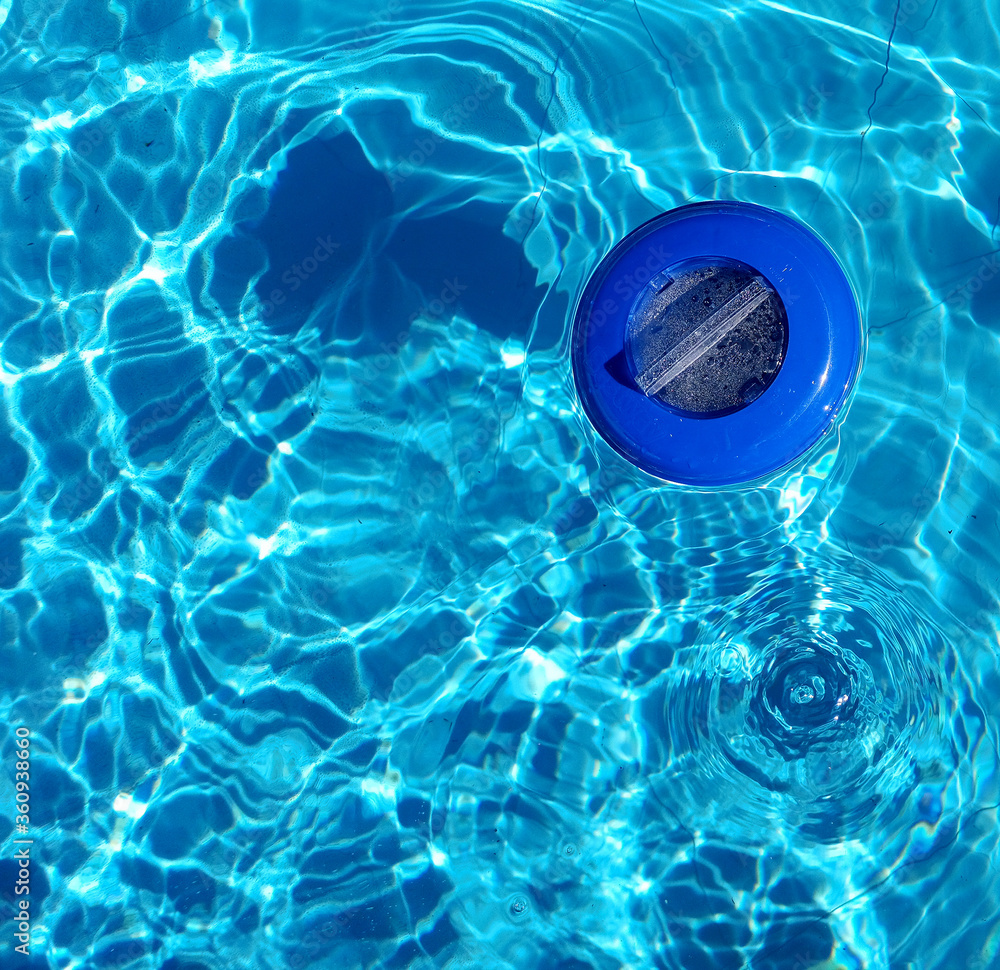 Plastic chlorine dispenser and blue water seen from above Stock Photo ...