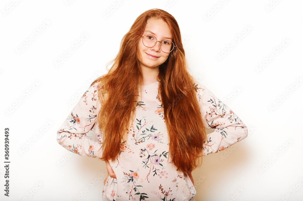 Studio portrait of pretty young teen girl with long red hair, posing on white background Studio portrait of pretty young teen girl with long red hair, posing on white background