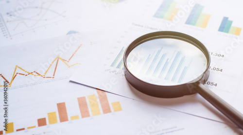 Foto Business concept with magnifying glass on documents