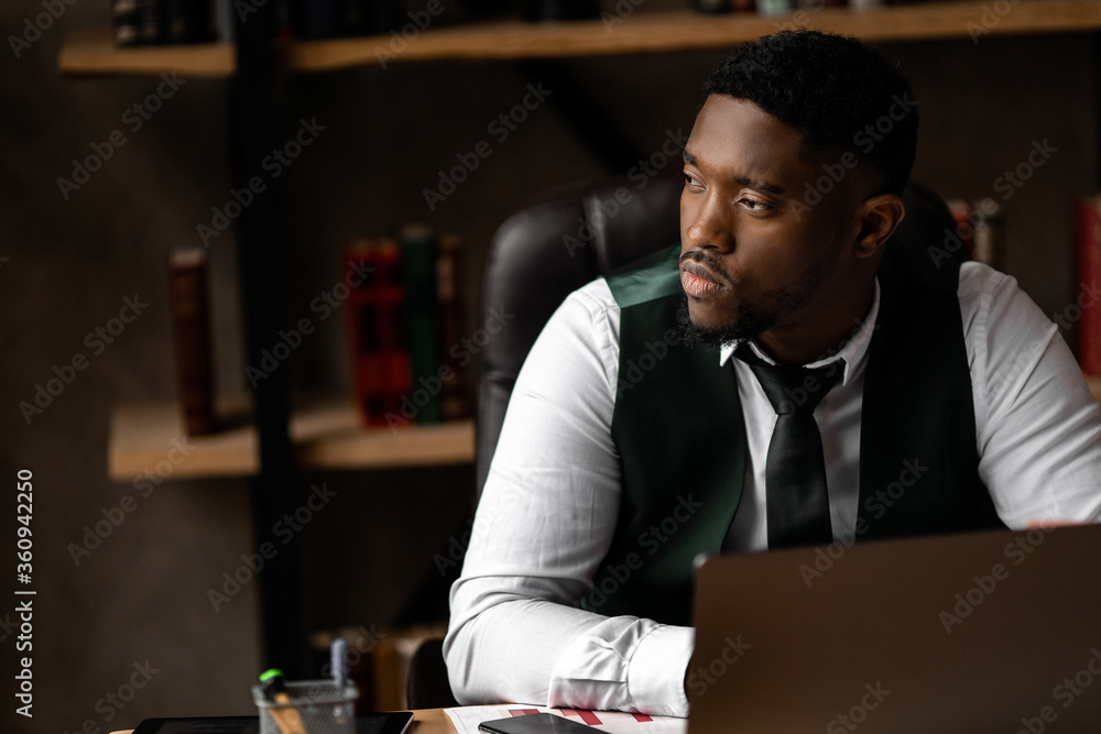 Handsome african business man working wirh laptop in modern office Handsome african business man working wirh laptop in modern office