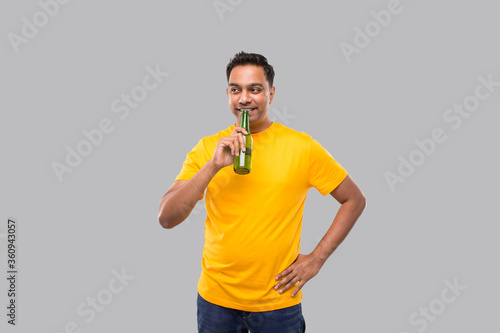 Indian man Drinking Beer from Beer bottle Isolated.