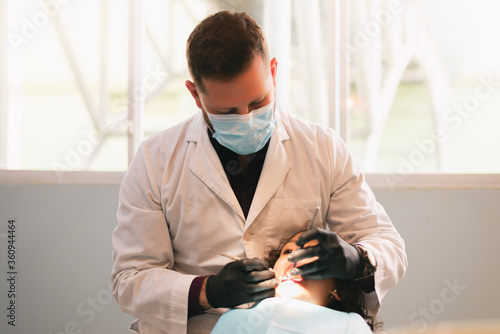 girl being cared for by a dentist in a hospital