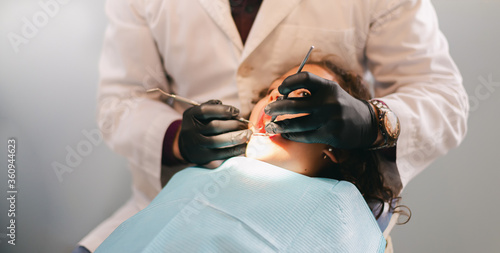 dentist treating girl during a dental health session at a hospital