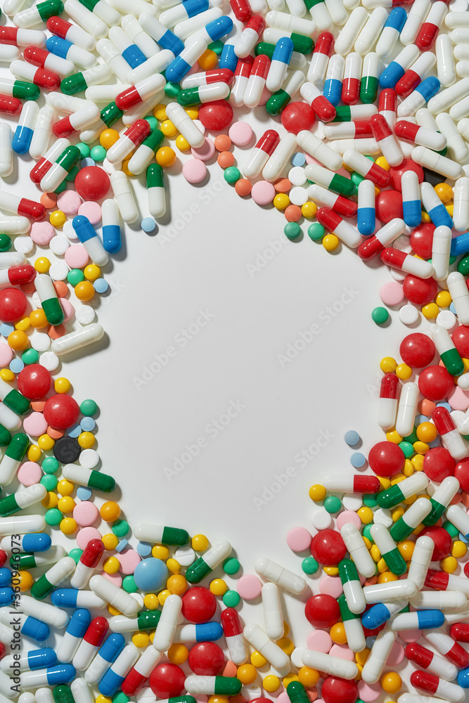 Different pills, capsules scattered in the shape of circle over white background. Health care, vitamins and treatment concept Different pills, capsules scattered in the shape of circle over white background. Health care, vitamins and treatment concept