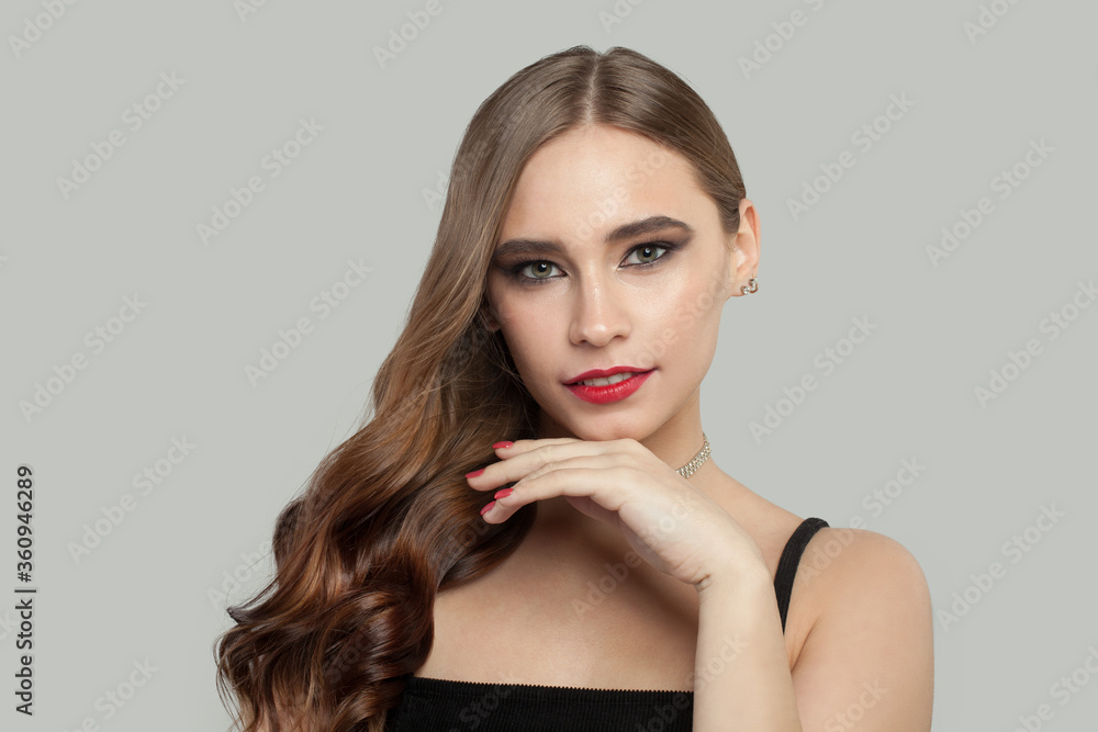 Nice young woman with red lips makeup and long brown curly hair portrait Nice young woman with red lips makeup and long brown curly hair portrait