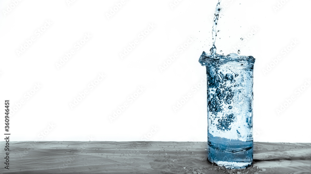 Fresh blue water pouring into a clear glass drink isolated on white background. Natural resource concept Fresh blue water pouring into a clear glass drink isolated on white background. Natural resource concept