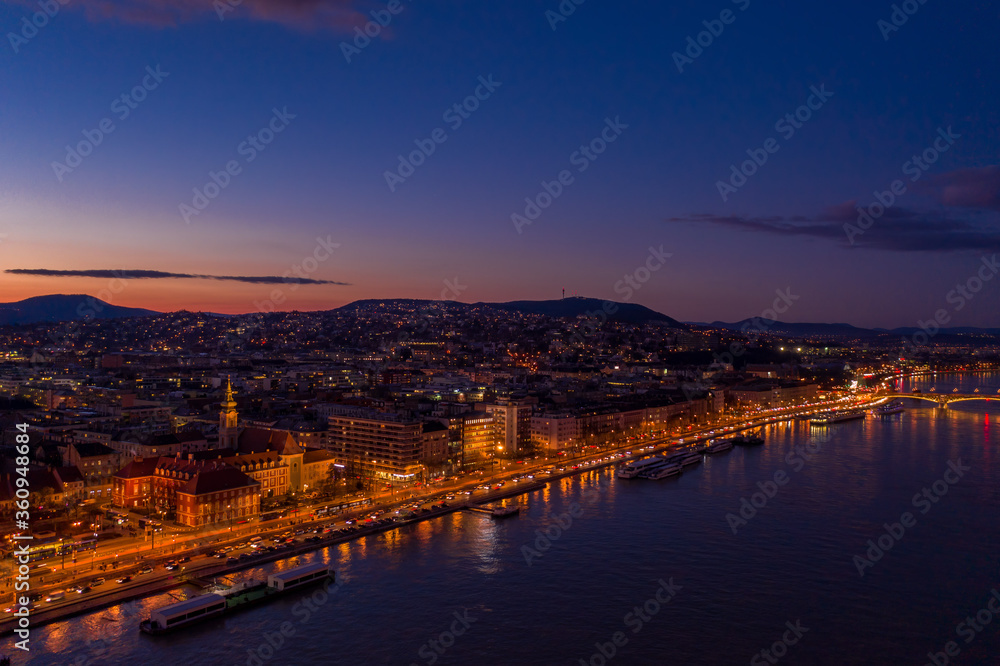 Aerial drone shot of Danube riverbank Buda hill side during Budapest sunset hour