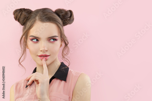 Young thinking woman with makeup and up do hair
