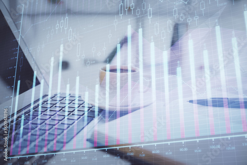 Double exposure of financial chart drawing and desktop with coffee and items on table background. Concept of forex market trading