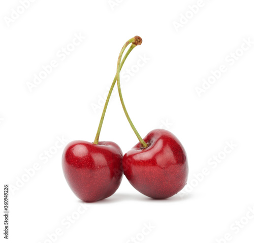 two red connected sweet cherries isolated on a white background