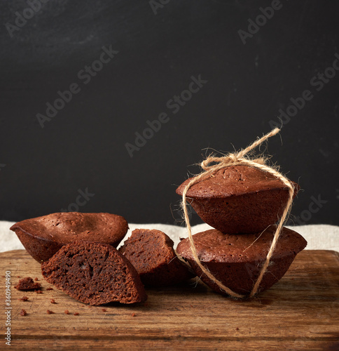 stack of baked brownie round cakes tied with a rope on a brown wooden board