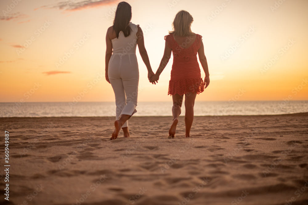 Fototapeta premium Los Cabos / Mexico- Feb 2019 Lesbian Love concept, sunset Lesbian, adjective to characterize or associate nouns with female homosexuality or same-sex attraction.