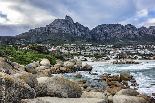 Wonderful Camps Bay nature (Kampsbaai) before sunset - affluent suburb of Cape Town. Camps Bay bordered by spectacular Twelve Apostles Mountain and glittering Atlantic Ocean. Camps Bay, South Africa.