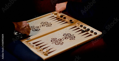 Senior couple playing classical backgammon, club evening 