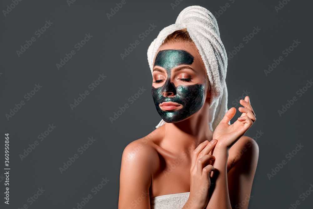 Beautiful woman with green peel-off mask on a gray background. Beautiful woman with green peel-off mask on a gray background.