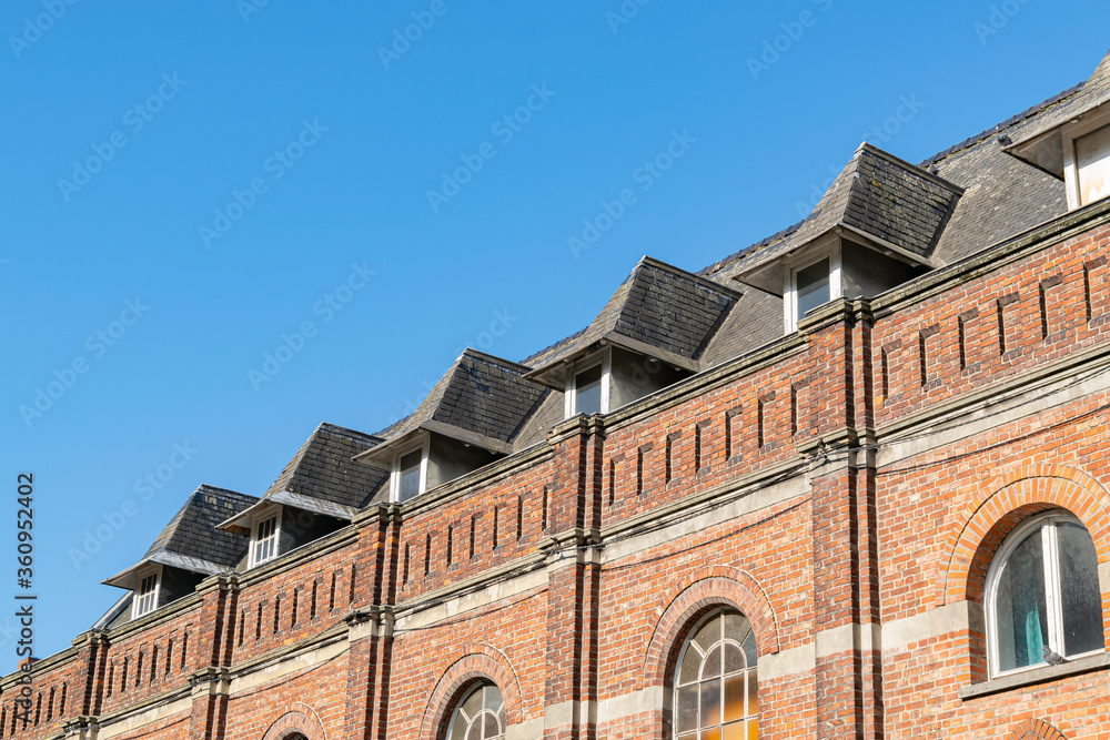 Architecture and details of an old tenement house built of brick.Sideways view.