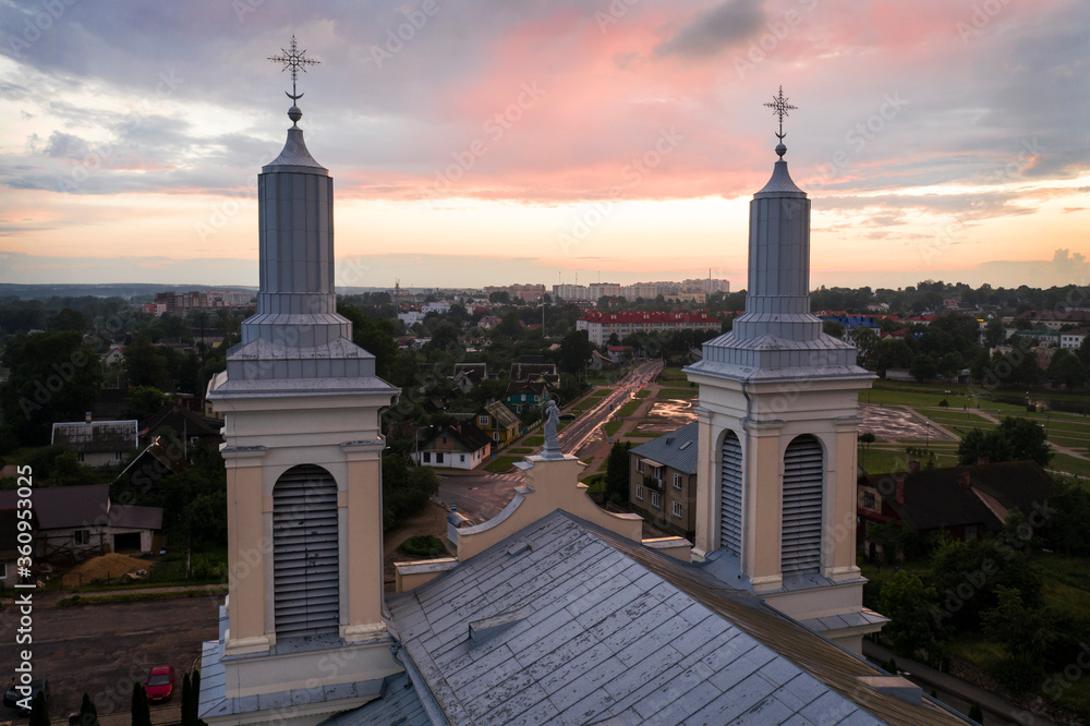 Fototapeta premium Beautiful church in the style of late classicism in the city center at sunset in summer. aerial photography