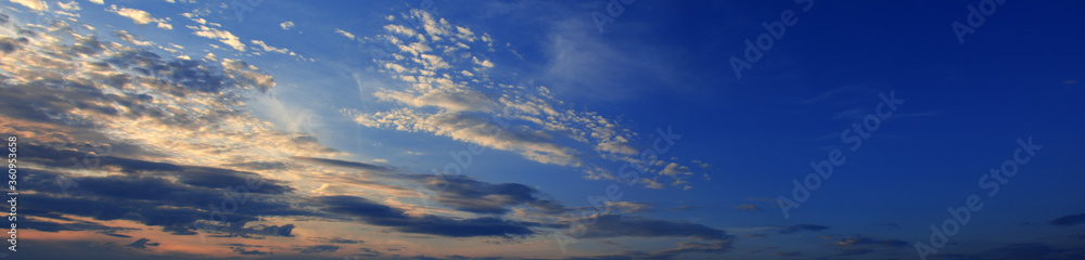 Sky at sunset with dark clouds, panoramic big shot. Background from the cloudy sky