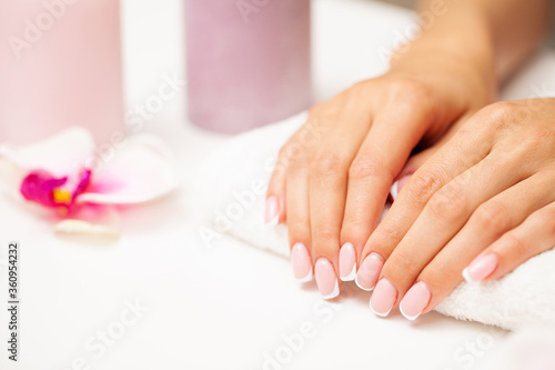 Nail care, woman demonstrates a fresh manicure done in a beauty studio