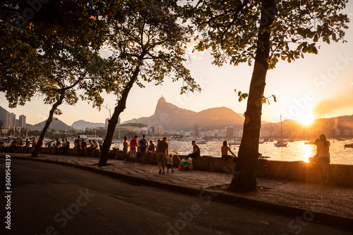 Beautiful sunset view to Urca ocean shore with people socializing photo
