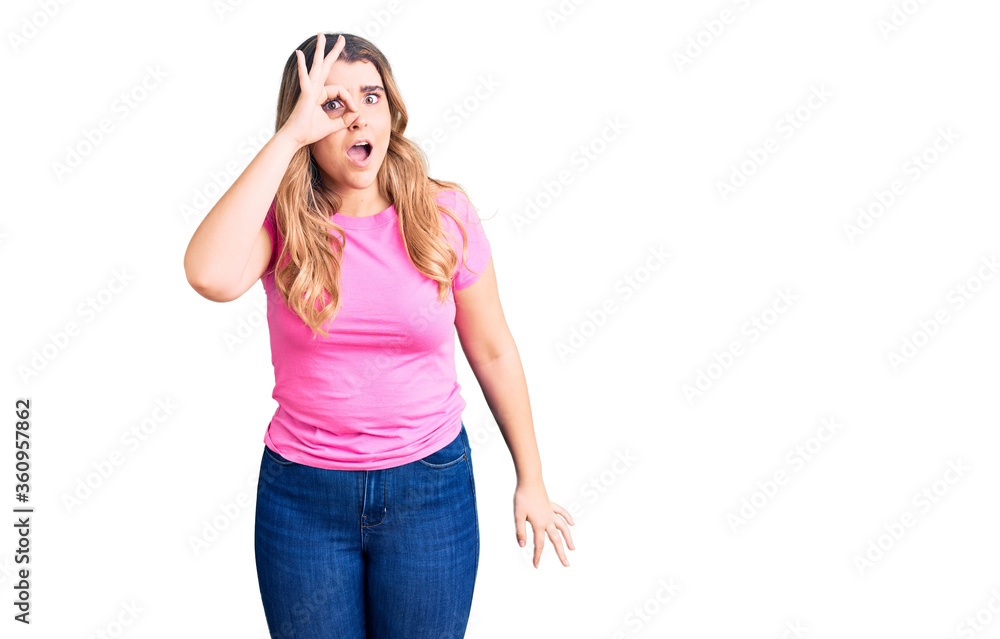Young caucasian woman wearing sportswear doing ok gesture shocked with surprised face, eye looking through fingers. unbelieving expression. Young caucasian woman wearing sportswear doing ok gesture shocked with surprised face, eye looking through fingers. unbelieving expression.