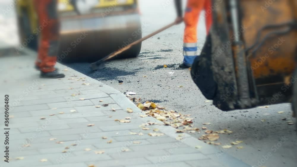 Road repair. Road workers lay asphalt Road repair. Road workers lay asphalt