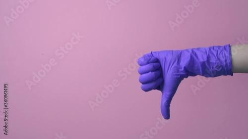 A hand in a glove shows a gesture thumbs up, and then a gesture thumbs down.