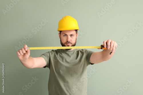 Male worker with tape measu...