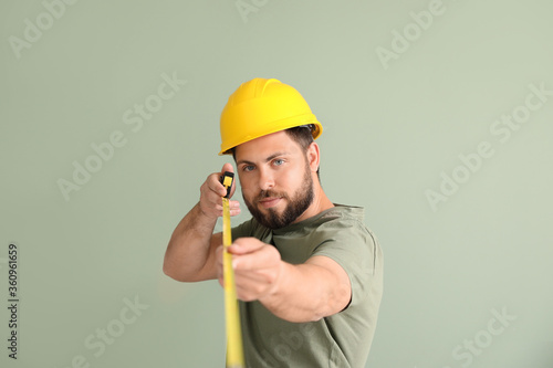 Male worker with tape measu...