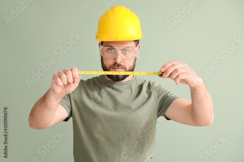Male worker with tape measu...