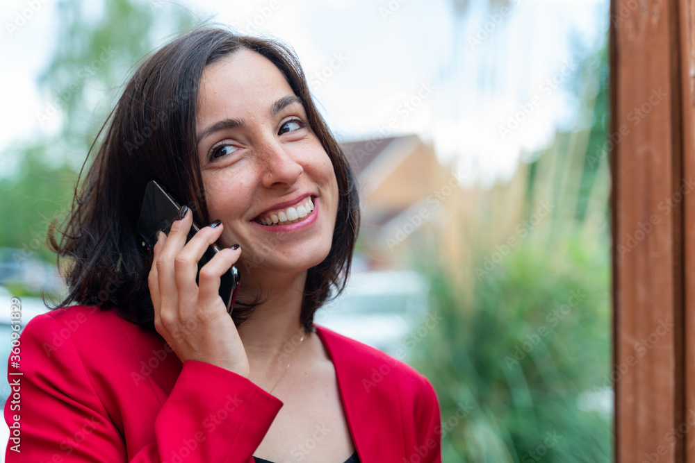 Young business woman speaking on the phone. Getting happy news. Business and technology concept Young business woman speaking on the phone. Getting happy news. Business and technology concept