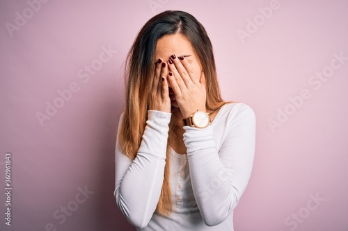 Young beautiful blonde woman with blue eyes wearing white t-shirt over pink background rubbing eyes for fatigue and headache, sleepy and tired expression. Vision problem © Krakenimages.com